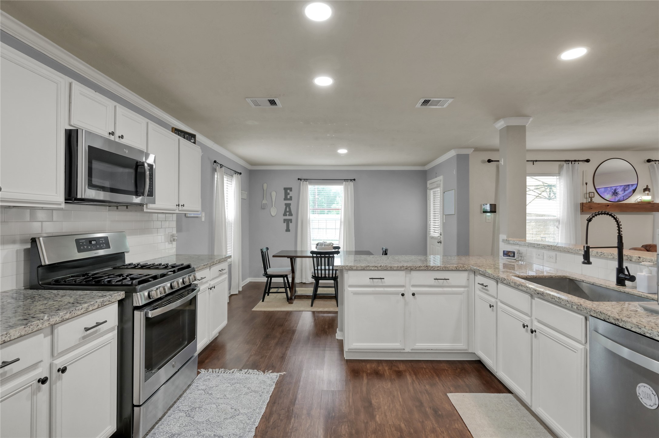 21610 Falvel Misty Drive Spring, TX 77388 - Photo 9 of 28 A beautifully renovated kitchen with granite countertops, stainless steel appliances, and painted cabinets