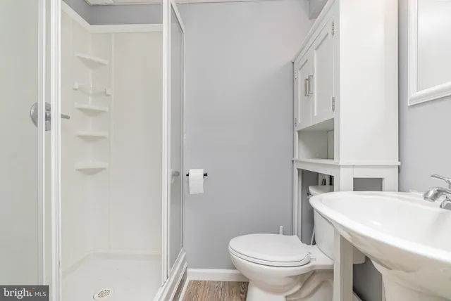 a bathroom with a sink toilet and shower