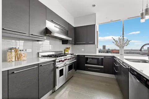 a kitchen with stainless steel appliances granite countertop a stove and a sink