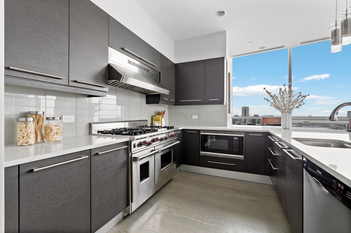 110 West Superior Street, Unit 2503 Chicago, IL 60654 - Photo 11 of 34 a kitchen with stainless steel appliances granite countertop a stove and a sink