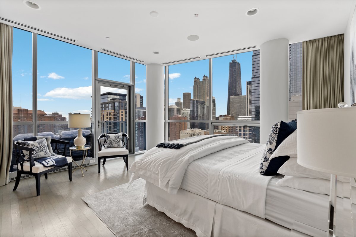 110 West Superior Street, Unit 2503 Chicago, IL 60654 - Photo 16 of 34 a bedroom with a bed and large windows