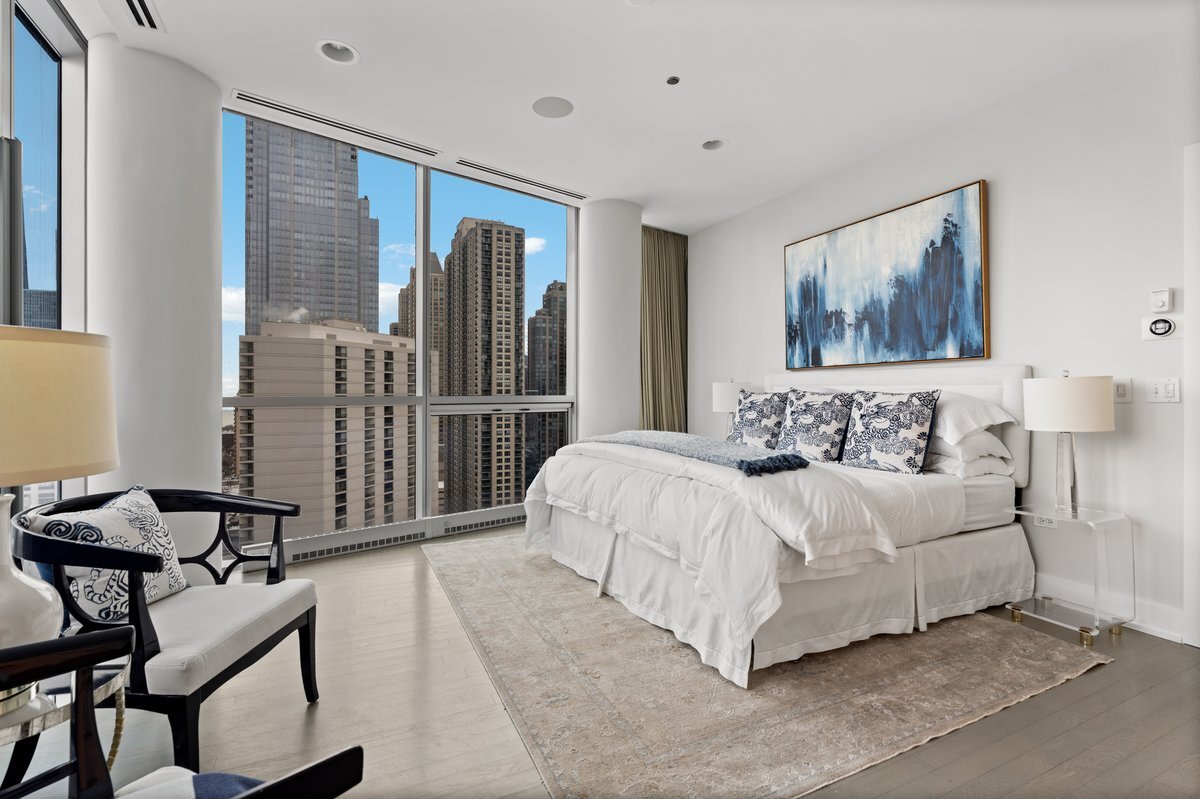 110 West Superior Street, Unit 2503 Chicago, IL 60654 - Photo 17 of 34 a spacious bedroom with a bed and glass window