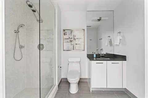 a bathroom with a toilet sink and shower