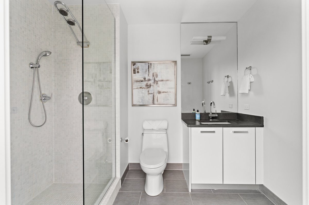 110 West Superior Street, Unit 2503 Chicago, IL 60654 - Photo 23 of 34 a bathroom with a toilet sink and shower