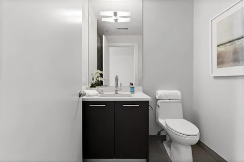 a bathroom with a toilet sink and mirror