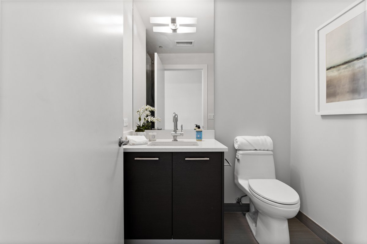 110 West Superior Street, Unit 2503 Chicago, IL 60654 - Photo 25 of 34 a bathroom with a toilet sink and mirror