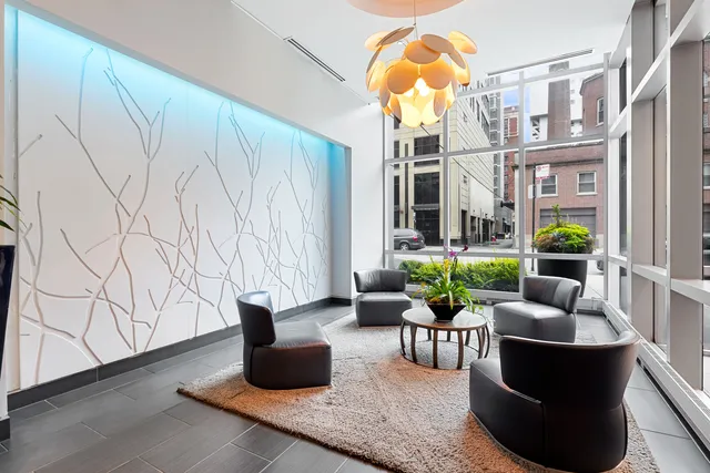 a living room with furniture and a potted plant