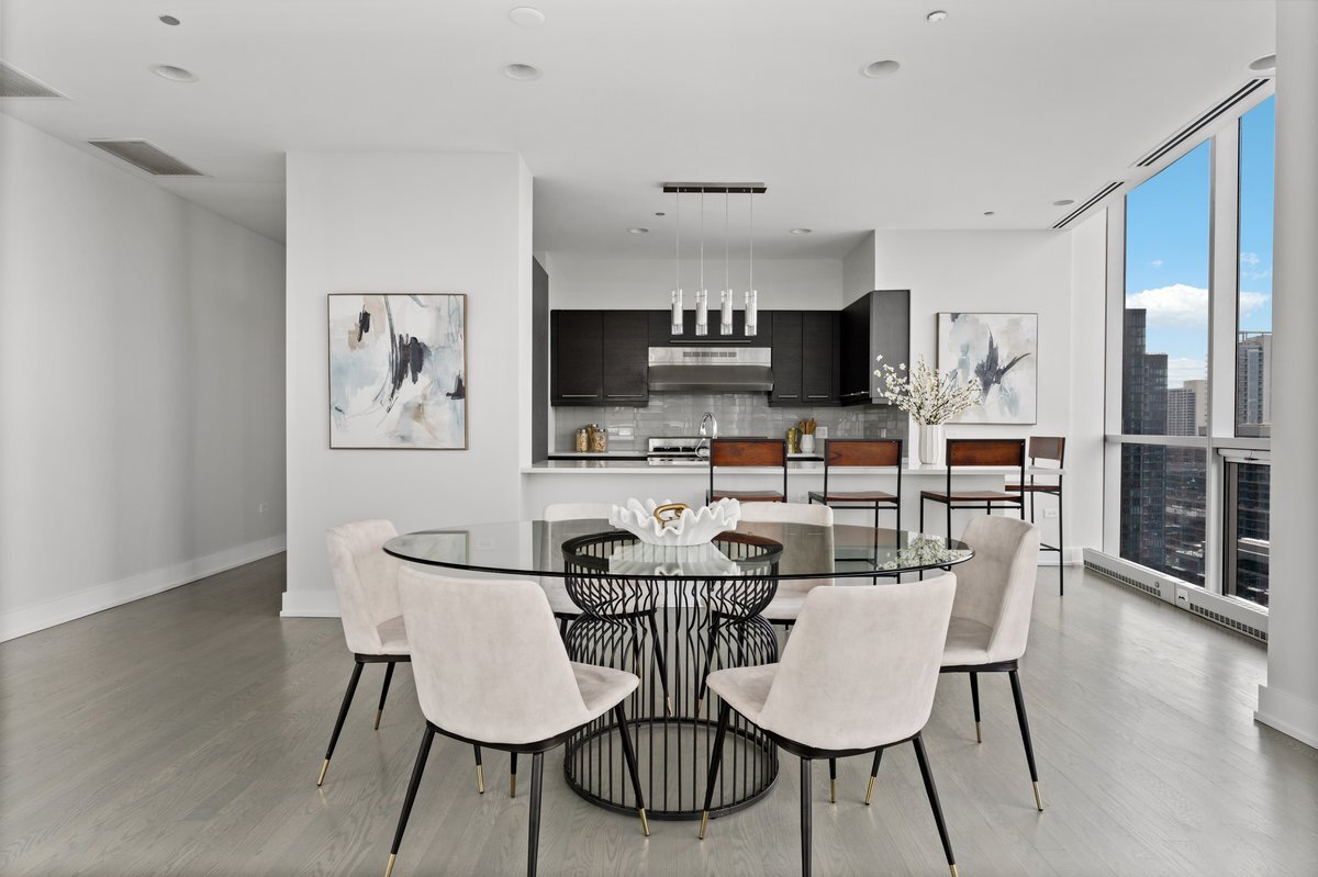 110 West Superior Street, Unit 2503 Chicago, IL 60654 - Photo 8 of 34 a view of a dining room with furniture and wooden floor
