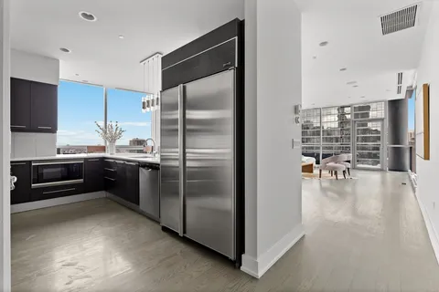 a kitchen with stainless steel appliances a refrigerator and a stove