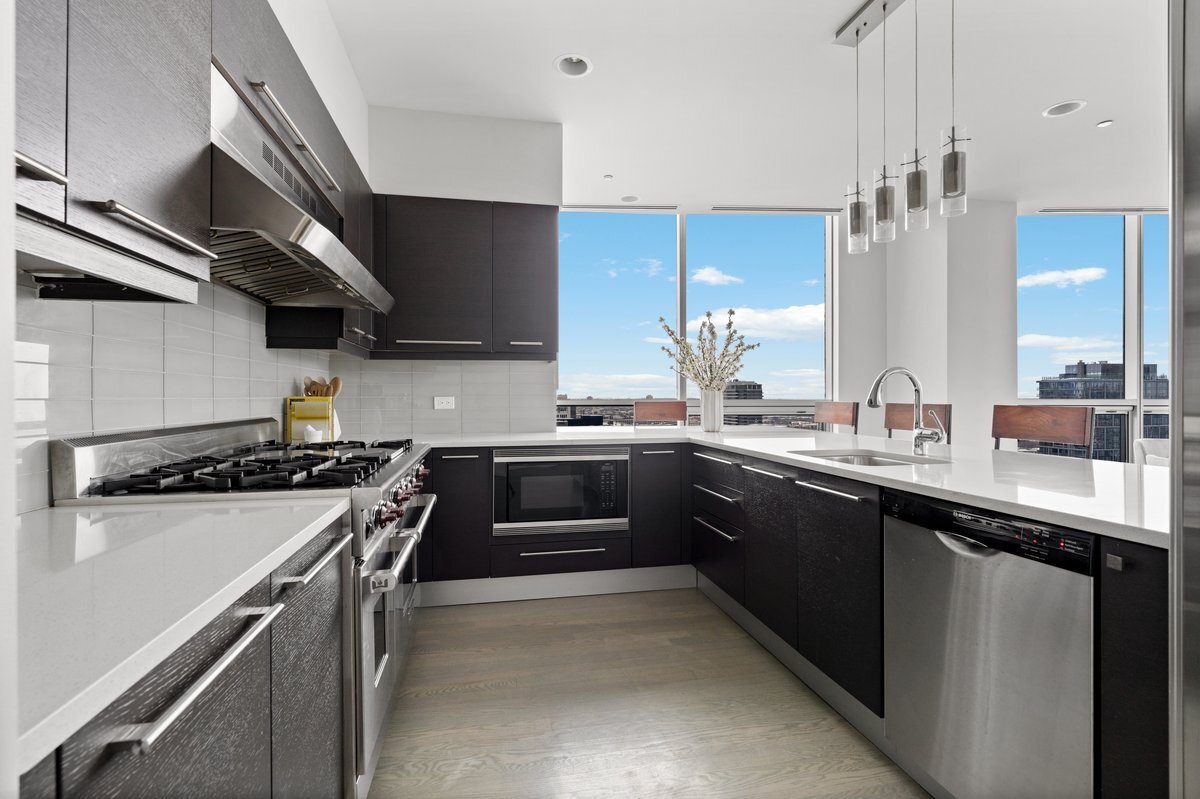 110 West Superior Street, Unit 2503 Chicago, IL 60654 - Photo 10 of 34 a kitchen with stainless steel appliances a sink and a stove