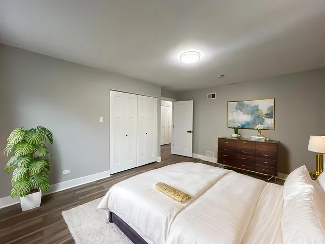 a bedroom with a bed and a lamp