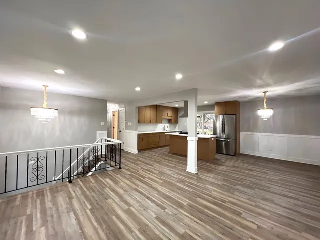 a view of kitchen with furniture and wooden floor