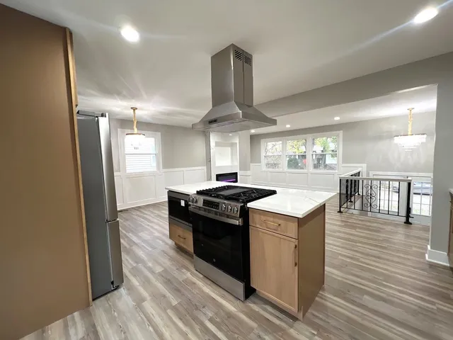 workspace with wooden floor fireplace and windows