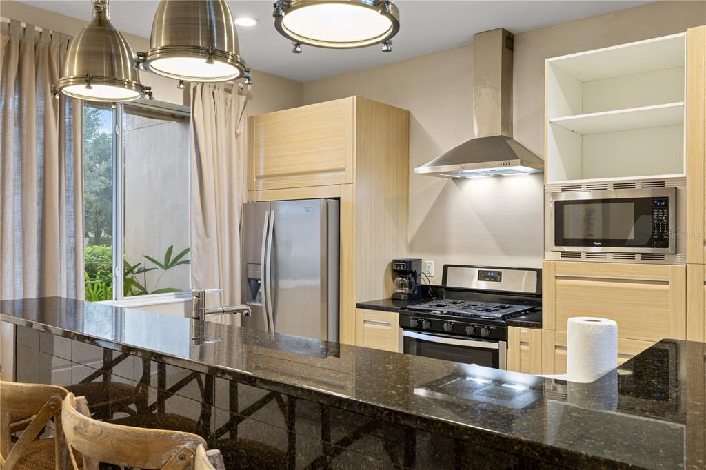 7657 Amazonas Street Kissimmee, FL 34747 - Photo 15 of 53 a kitchen with stainless steel appliances a stove a sink and a refrigerator