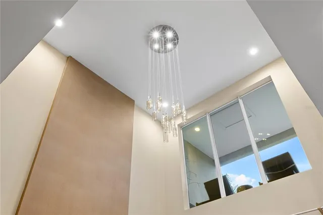 a living room with furniture large window and flat screen tv