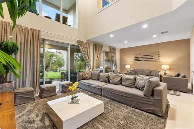 a living room with furniture and a view of kitchen