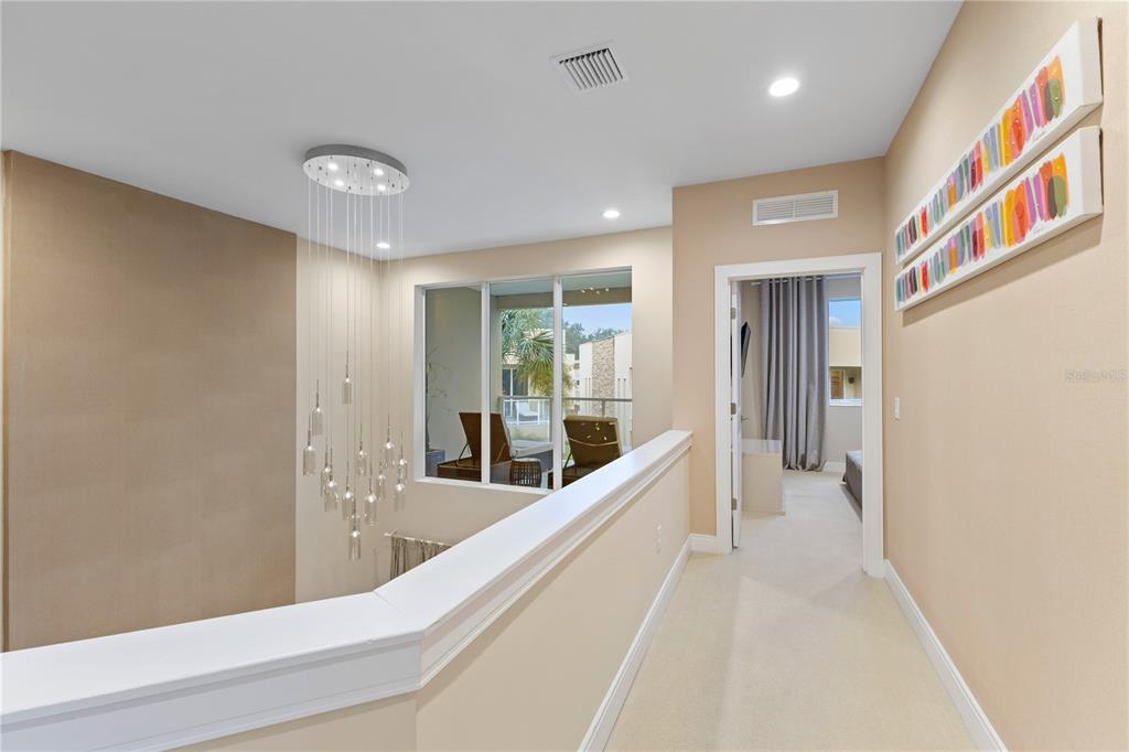 7657 Amazonas Street Kissimmee, FL 34747 - Photo 28 of 53 a view of a hallway with large mirror and furniture