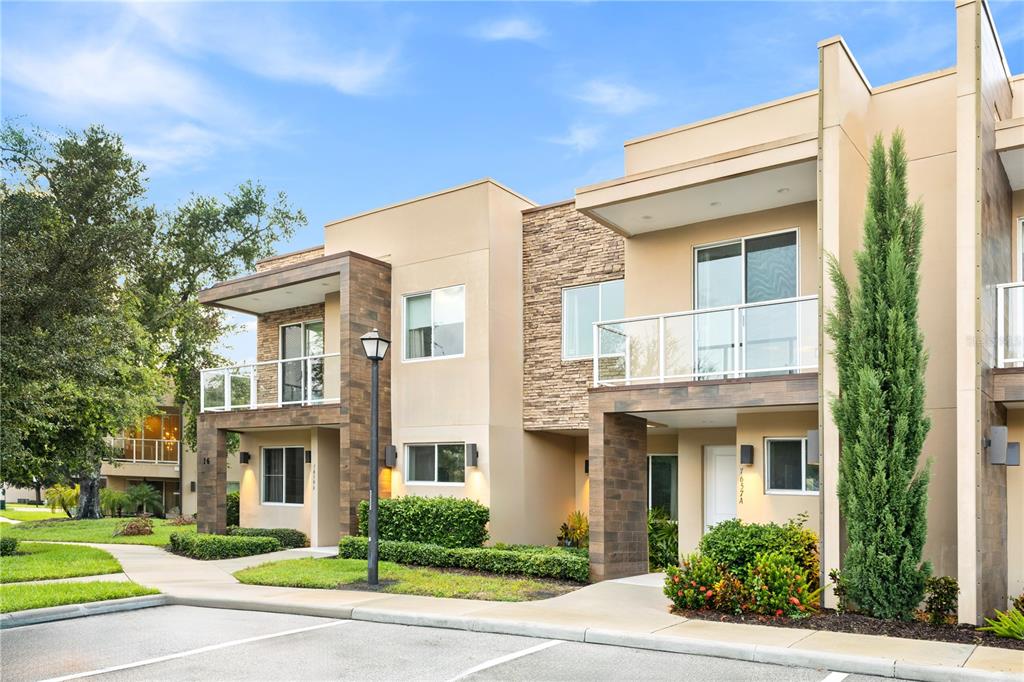 7657 Amazonas Street Kissimmee, FL 34747 - Photo 3 of 53 a front view of a building with garden