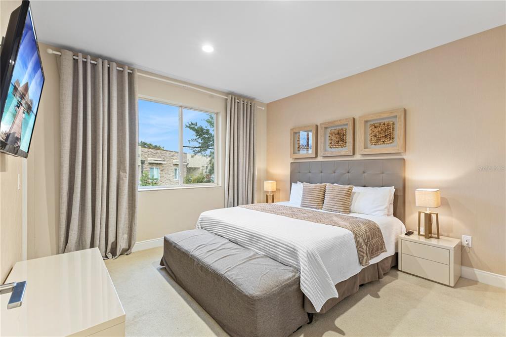 7657 Amazonas Street Kissimmee, FL 34747 - Photo 32 of 53 a bedroom with a large bed and a window