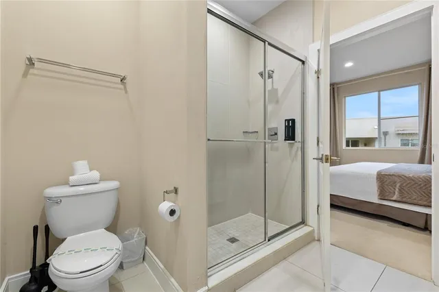 a bedroom with two beds and a painting on the wall