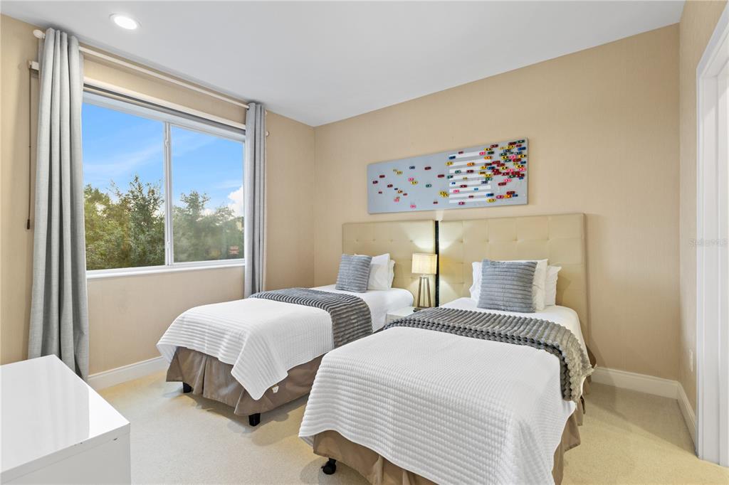 7657 Amazonas Street Kissimmee, FL 34747 - Photo 39 of 53 a bedroom with two beds and a large window