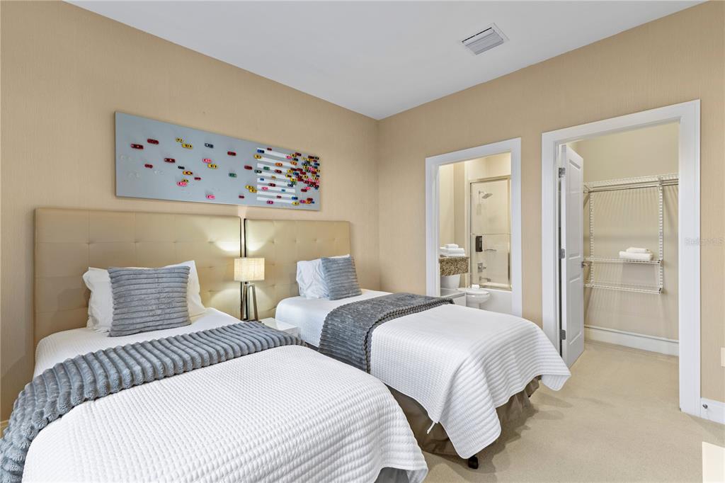 7657 Amazonas Street Kissimmee, FL 34747 - Photo 40 of 53 a bedroom with two beds and a painting on the wall