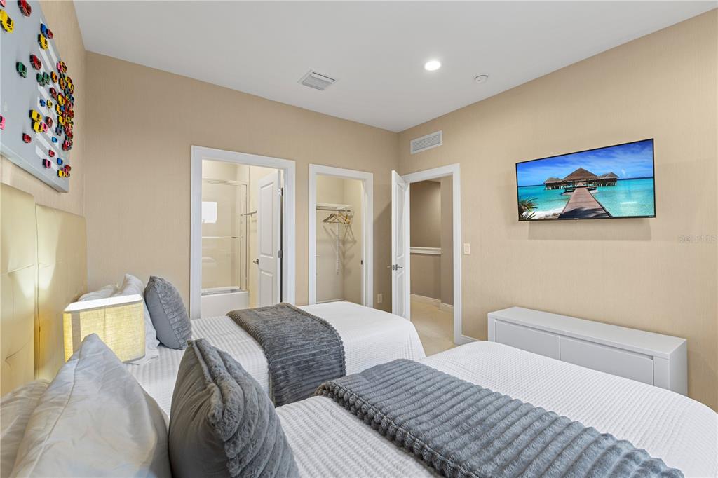 7657 Amazonas Street Kissimmee, FL 34747 - Photo 41 of 53 a bedroom with two beds and a painting on the wall