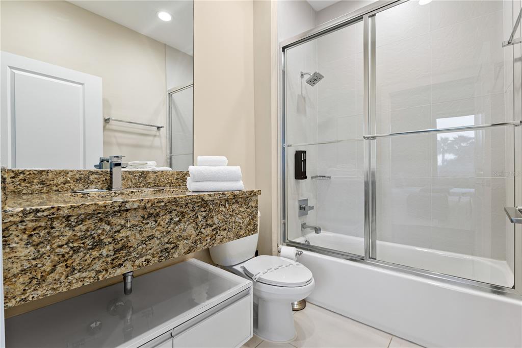7657 Amazonas Street Kissimmee, FL 34747 - Photo 42 of 53 a bathroom with a granite countertop sink toilet and shower