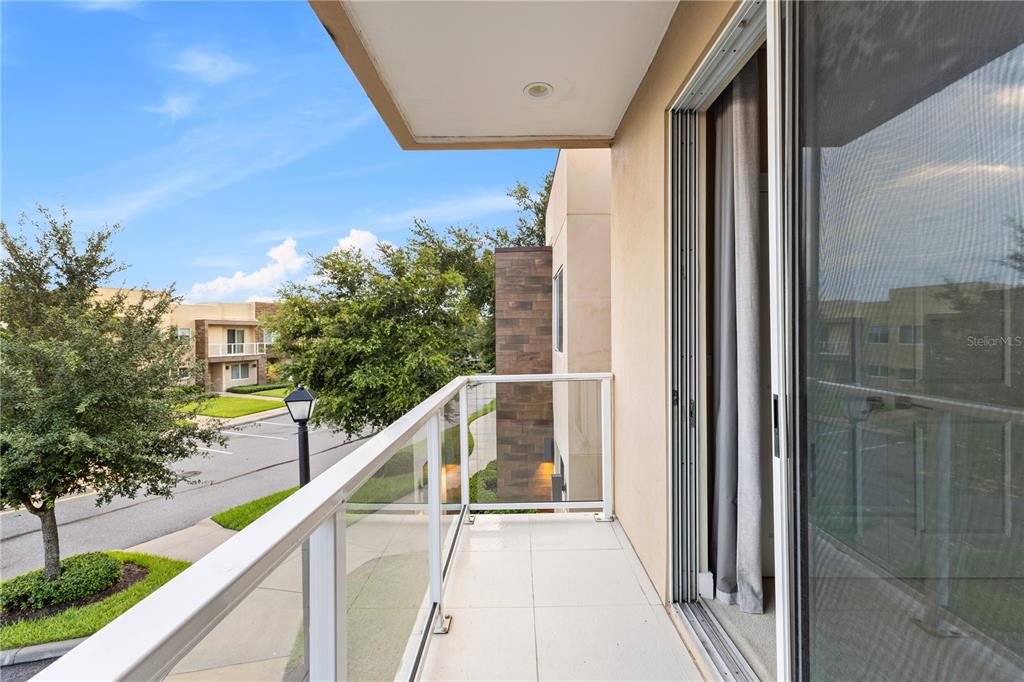 7657 Amazonas Street Kissimmee, FL 34747 - Photo 45 of 53 a view of a balcony with wooden floor and stairs