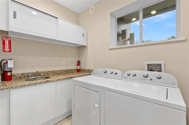 a bathroom with a granite countertop sink a toilet and a window