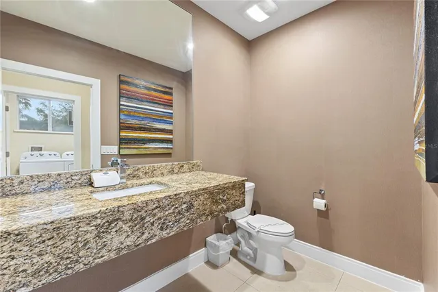 a kitchen with stainless steel appliances kitchen island granite countertop a stove a sink and a refrigerator