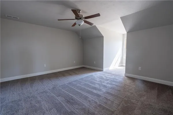 a view of a livingroom with a ceiling fan and wooden floor