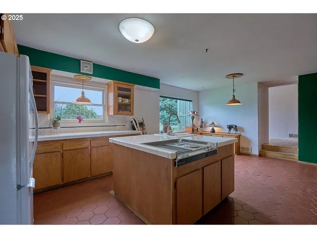 a kitchen with a sink and a stove top oven