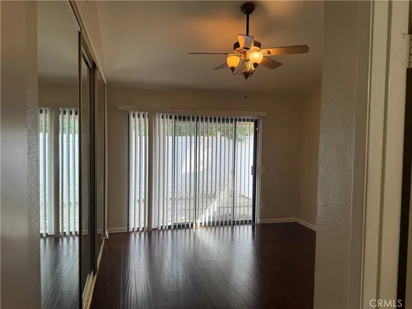 a view of an empty walk in closet with wooden floor
