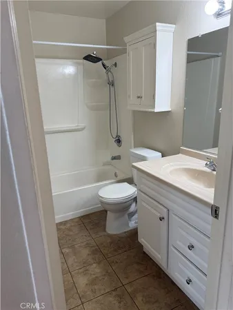 an empty room with wooden floor and window