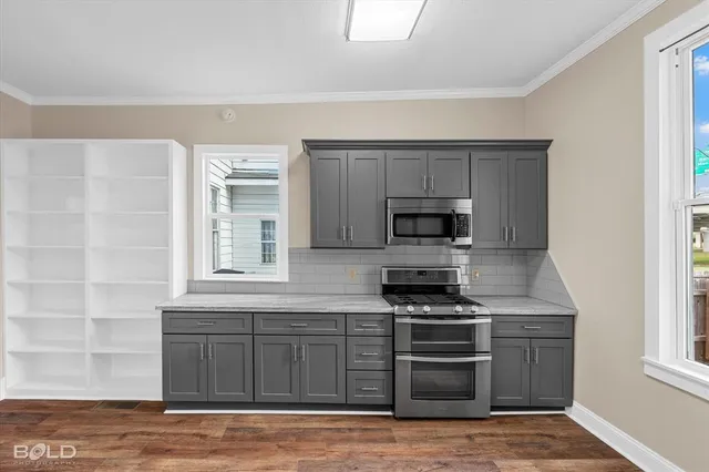 a kitchen with a sink refrigerator and cabinets