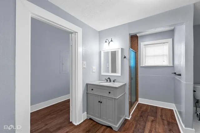 a bathroom with a shower and a sink