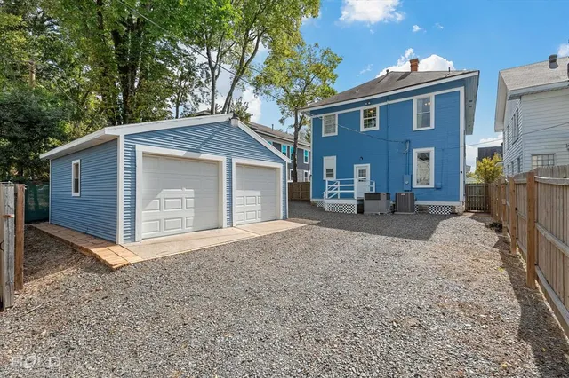 a view of a house with a yard and potted plants