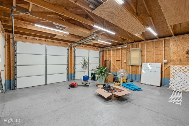 an aerial view of residential houses with outdoor space and river