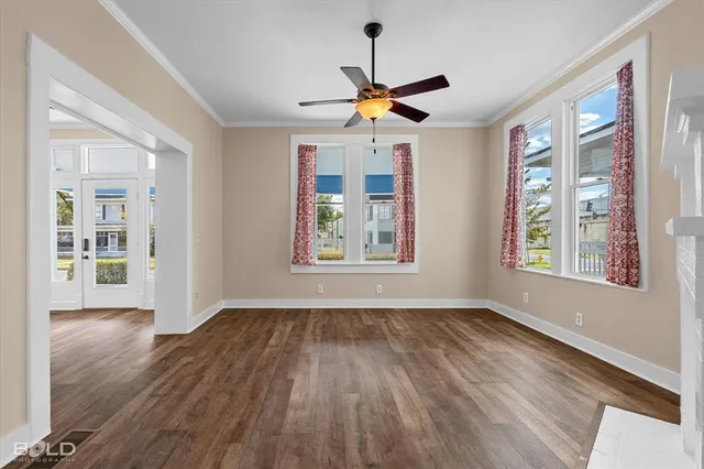 a view of empty room with wooden floor