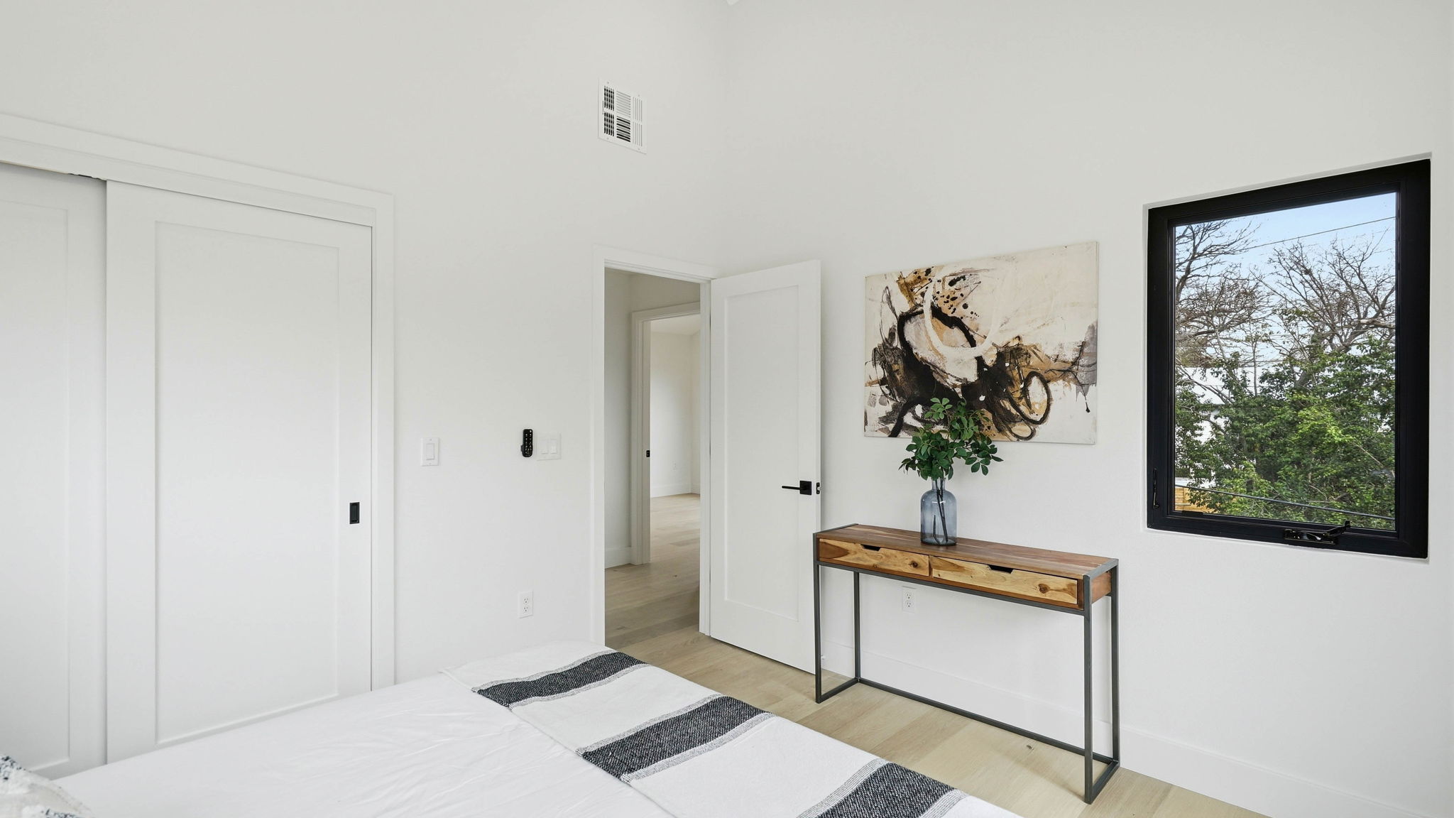 300 Lightsey Road, Unit 2 Austin, TX 78704 - Photo 22 of 28 Bedroom featuring light wood-style flooring, a closet, and a high ceiling