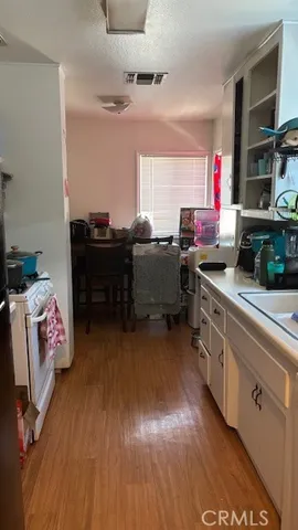 a kitchen with a sink and a stove top oven