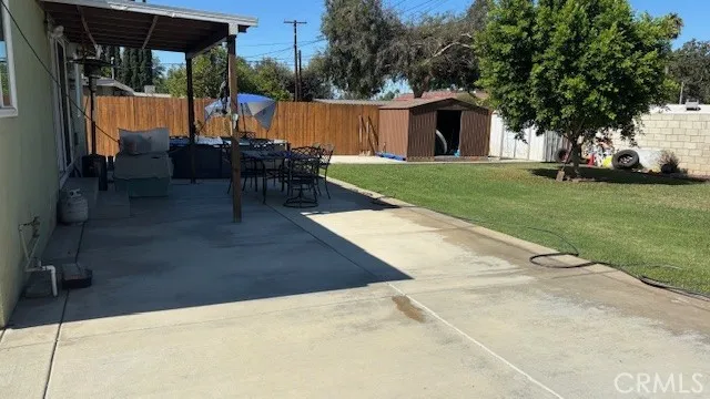a view of backyard with swimming pool and seating space