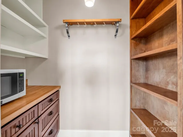 a view of walk in closet with clothes
