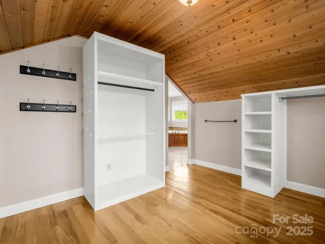 a view of a room with wooden floor and cabinet