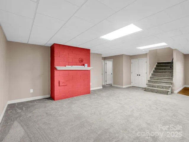 a view of an empty room with a fireplace