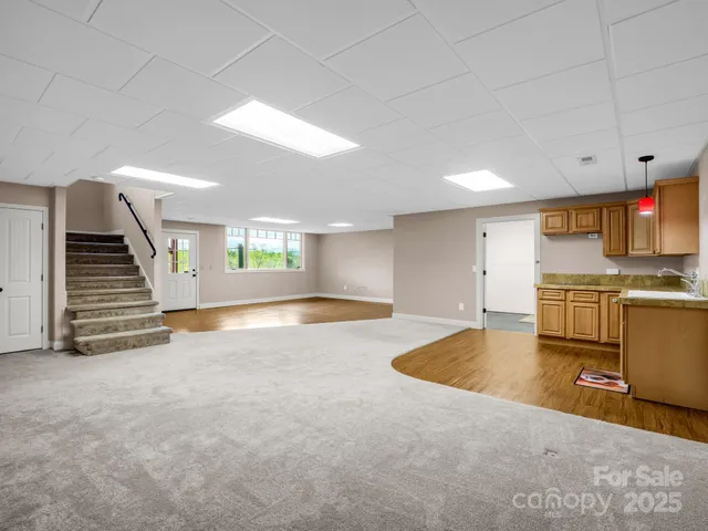 a view of kitchen and hall with wooden floor