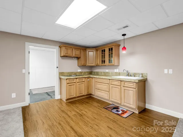 a kitchen with stainless steel appliances granite countertop a sink stove and cabinets