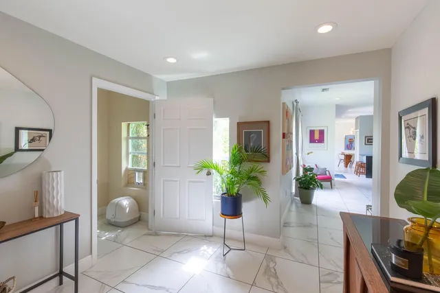 a living room with furniture and a potted plant
