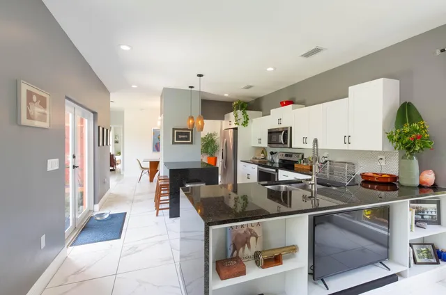 a kitchen with stainless steel appliances granite countertop a refrigerator and stove